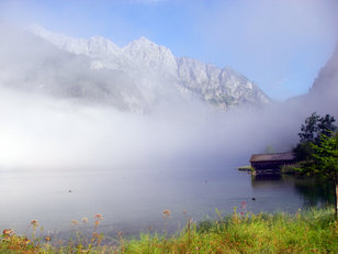 Bergsee mit Nebel und Felsgebirge 